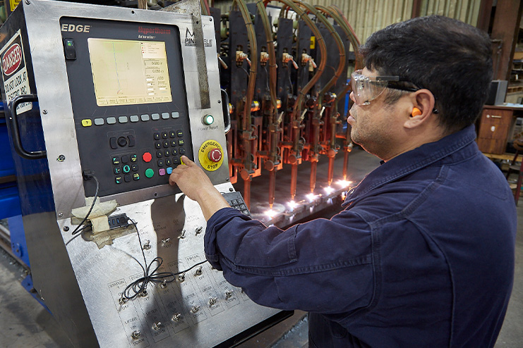 Employee setting up the flame cutter